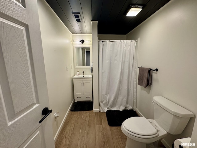 bathroom featuring wood ceiling, a shower with shower curtain, vanity, wood-type flooring, and toilet