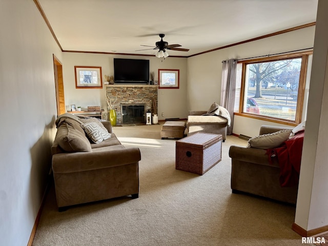 carpeted living room featuring a stone fireplace, ornamental molding, and ceiling fan