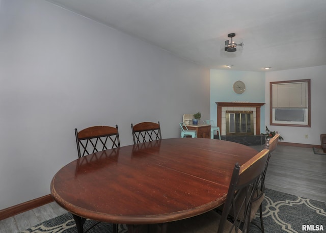 dining room featuring a fireplace and hardwood / wood-style floors