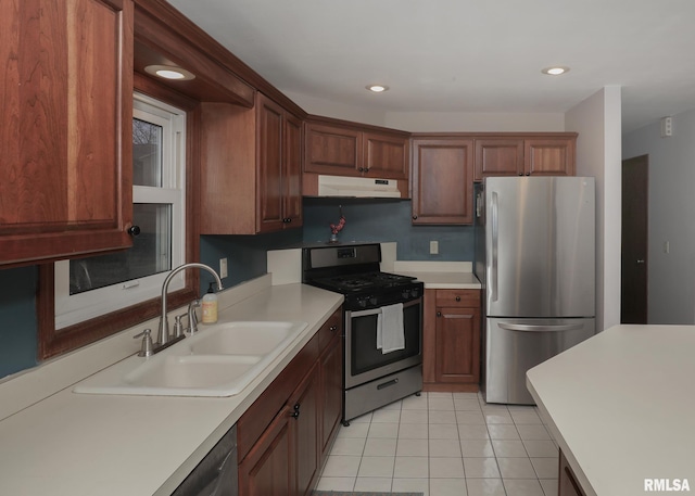 kitchen with stainless steel appliances, light tile patterned flooring, and sink