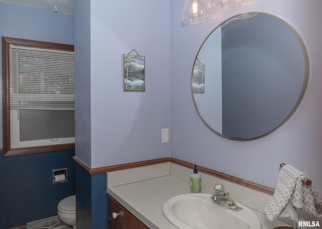 bathroom featuring vanity and toilet