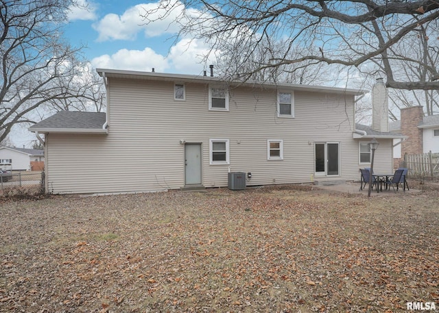 rear view of property with cooling unit and a patio area