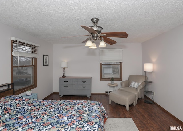 bedroom featuring ceiling fan, dark wood-type flooring, and a textured ceiling