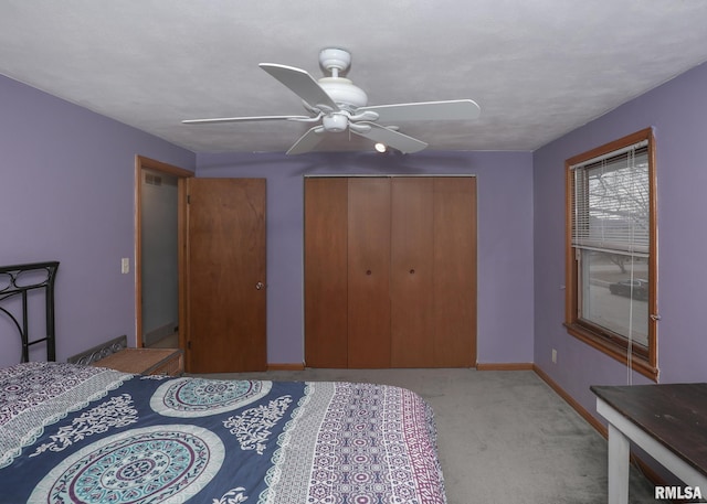 carpeted bedroom with ceiling fan and a closet