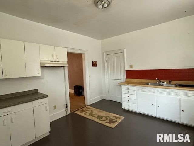 kitchen with white cabinetry, sink, and decorative backsplash