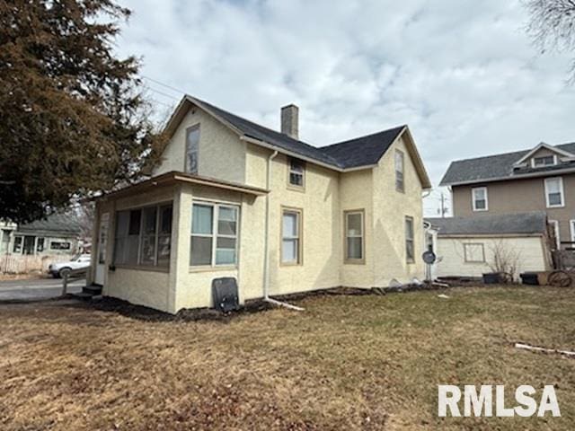 rear view of house with a yard