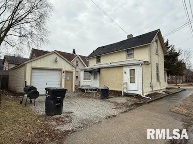 view of front of home featuring a garage and an outdoor structure