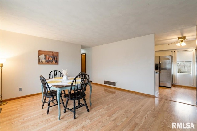 dining room with ceiling fan and light wood-type flooring