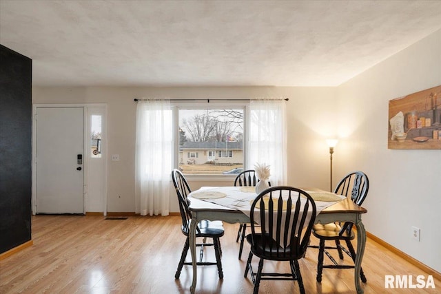 dining room with light wood-type flooring