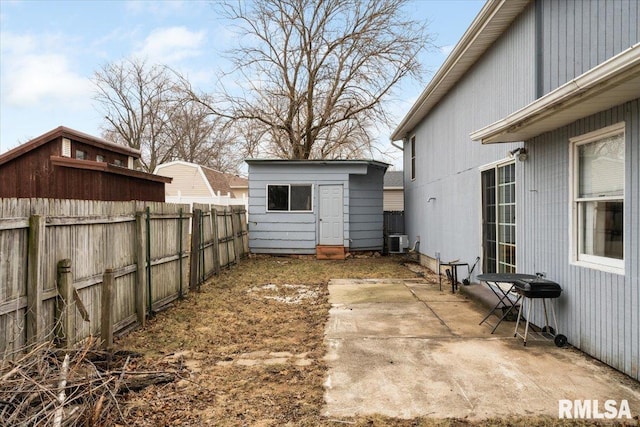 view of yard with central AC, a storage shed, and a patio