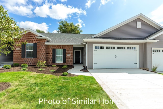 ranch-style home with a front yard and a garage