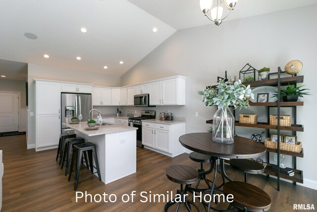 LOT39 Frank Ct, Le Claire, IA 52753 - kitchen featuring stainless steel appliances, an island with sink, light stone counters, white cabinets, and sink