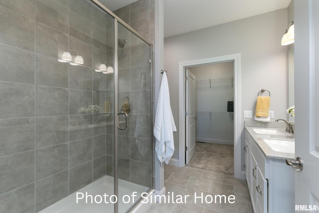 bathroom with vanity, tile patterned flooring, and a shower with door