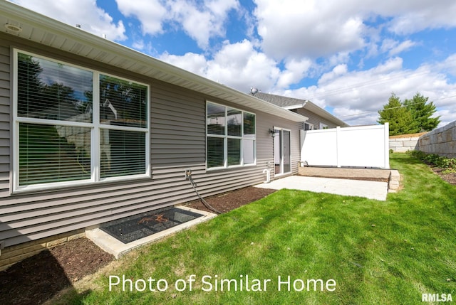 rear view of house featuring a patio and a lawn