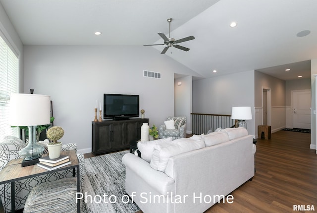 living room featuring vaulted ceiling, dark hardwood / wood-style floors, and ceiling fan