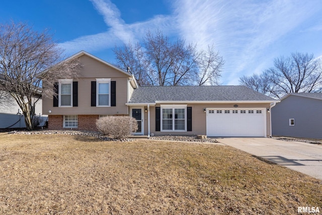 split level home featuring a garage and a front yard