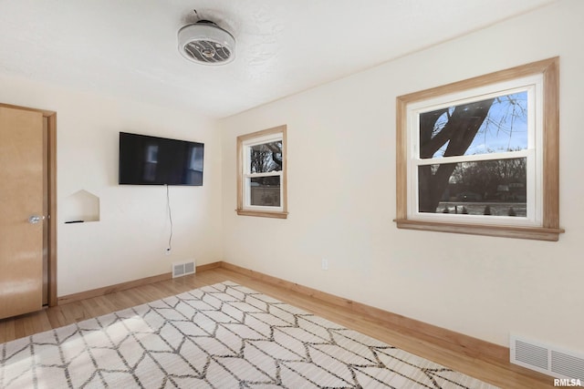 unfurnished room with wood-type flooring