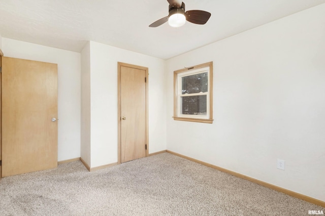 unfurnished bedroom featuring ceiling fan and light colored carpet