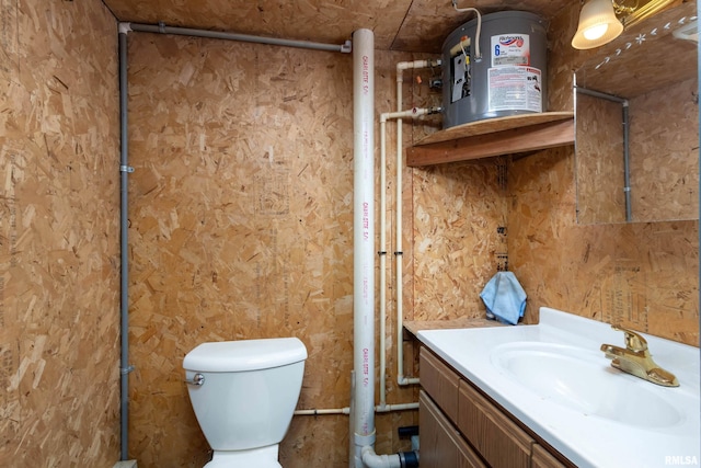 bathroom featuring water heater, vanity, and toilet