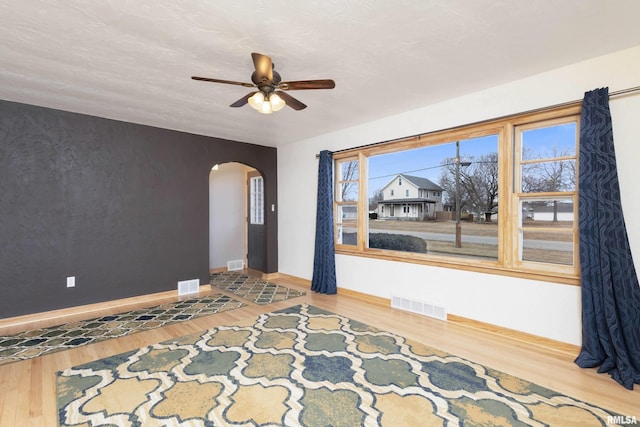 empty room featuring hardwood / wood-style floors and ceiling fan