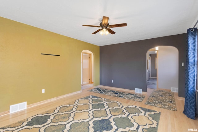 spare room with hardwood / wood-style floors and ceiling fan