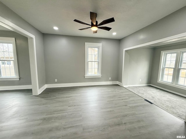 unfurnished room featuring ceiling fan and hardwood / wood-style floors