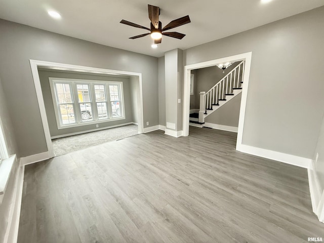 unfurnished living room featuring hardwood / wood-style flooring and ceiling fan