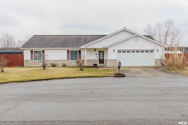 ranch-style house featuring a garage and a front yard