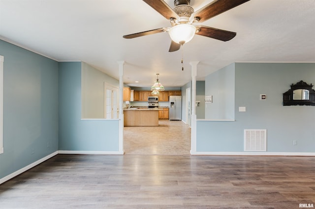 unfurnished living room featuring light hardwood / wood-style floors and ceiling fan