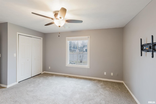 unfurnished bedroom featuring ceiling fan, carpet floors, and a closet