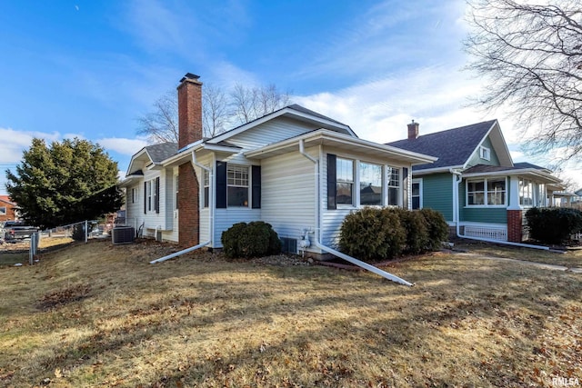 view of front of property featuring central AC and a front yard