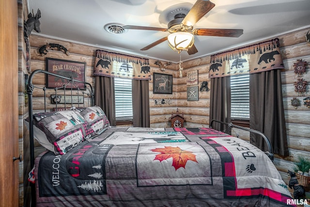 bedroom featuring log walls and ceiling fan