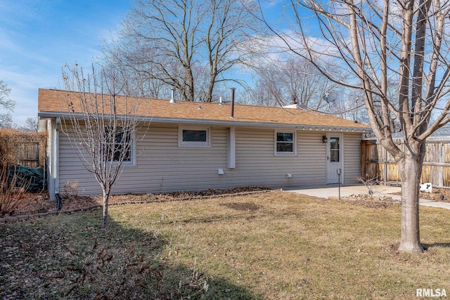 rear view of house with a patio area and a lawn