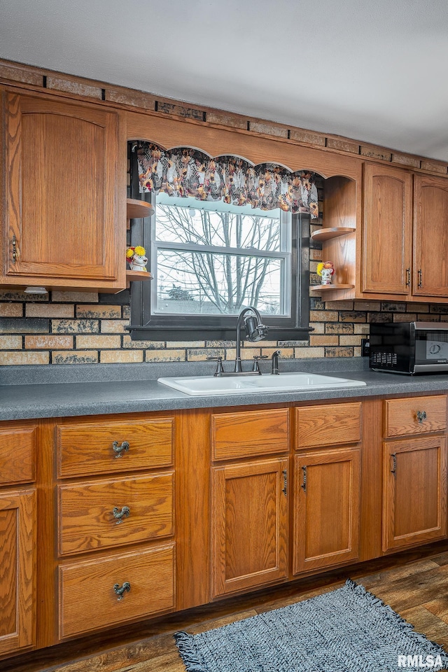 kitchen with sink and dark wood-type flooring