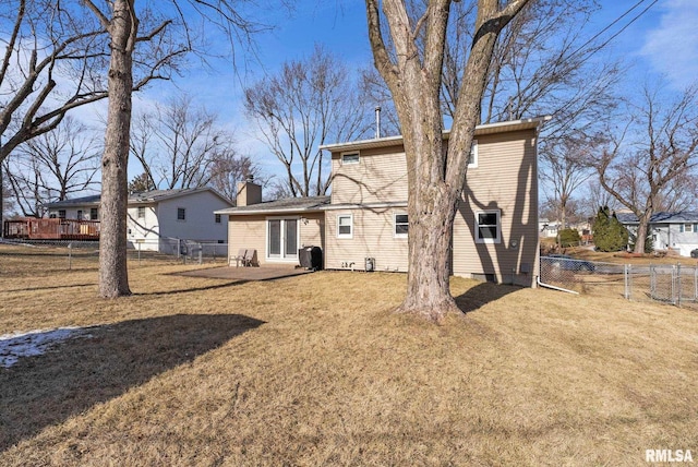 back of house with a lawn