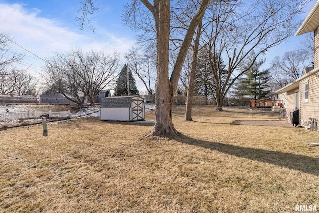 view of yard featuring a shed and a deck