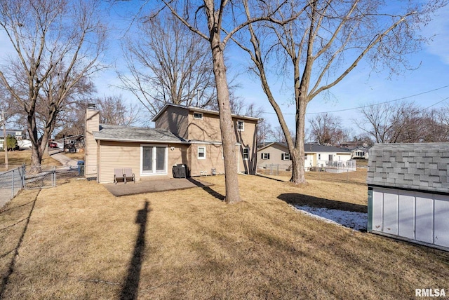 rear view of property featuring a storage shed and a lawn