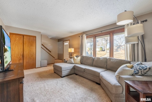 living room with a textured ceiling and carpet