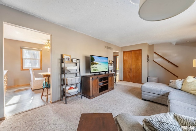 carpeted living room with a textured ceiling