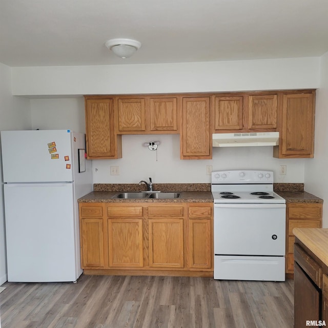 kitchen featuring sink, white appliances, and light hardwood / wood-style floors