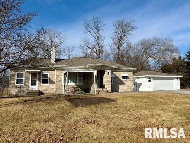 view of front of property with a garage and a front lawn