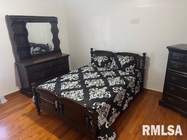 bedroom featuring wood-type flooring