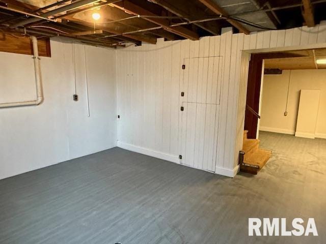 basement featuring dark hardwood / wood-style flooring