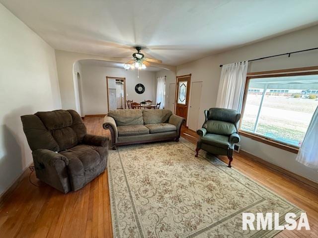 living room featuring ceiling fan and wood-type flooring