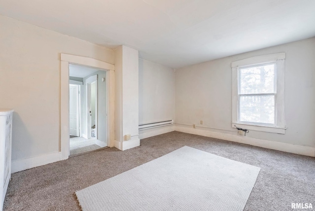 empty room with light colored carpet and baseboard heating