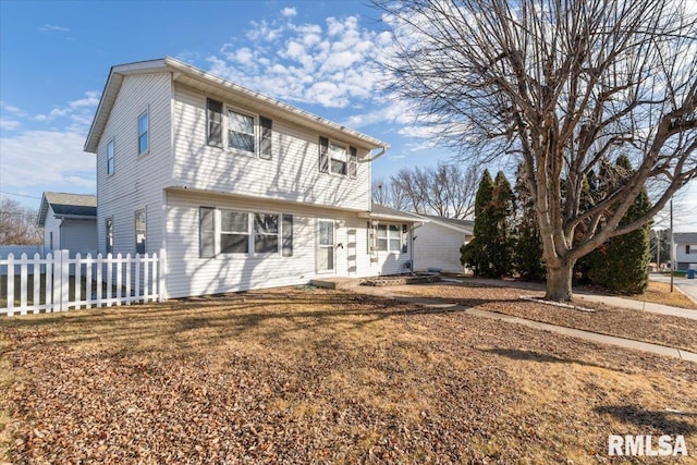 view of property featuring a front lawn