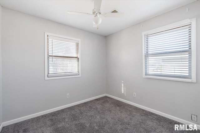 unfurnished room featuring ceiling fan and dark carpet