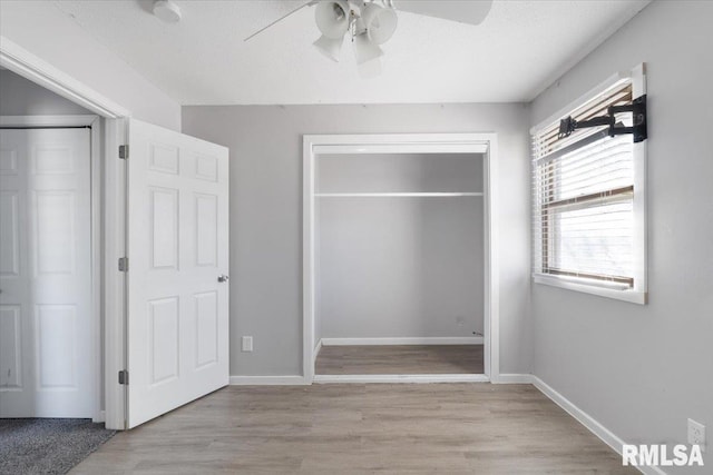 unfurnished bedroom featuring ceiling fan and light hardwood / wood-style floors