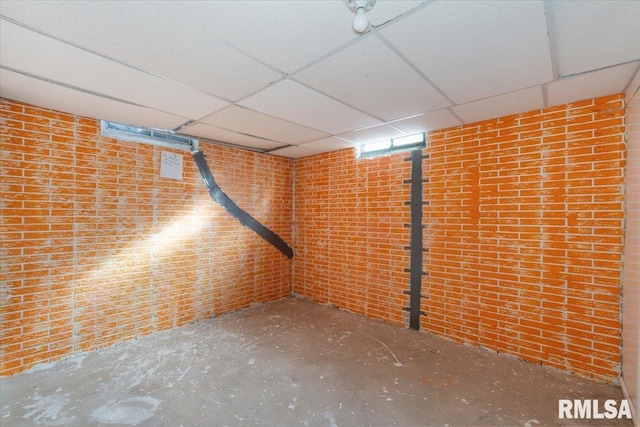 basement with a paneled ceiling