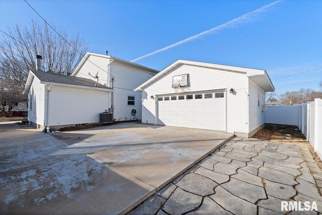 exterior space with a garage, an outdoor structure, and central air condition unit